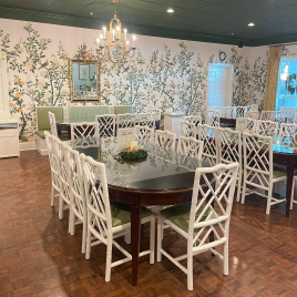 A dining room with a table and chairs in it