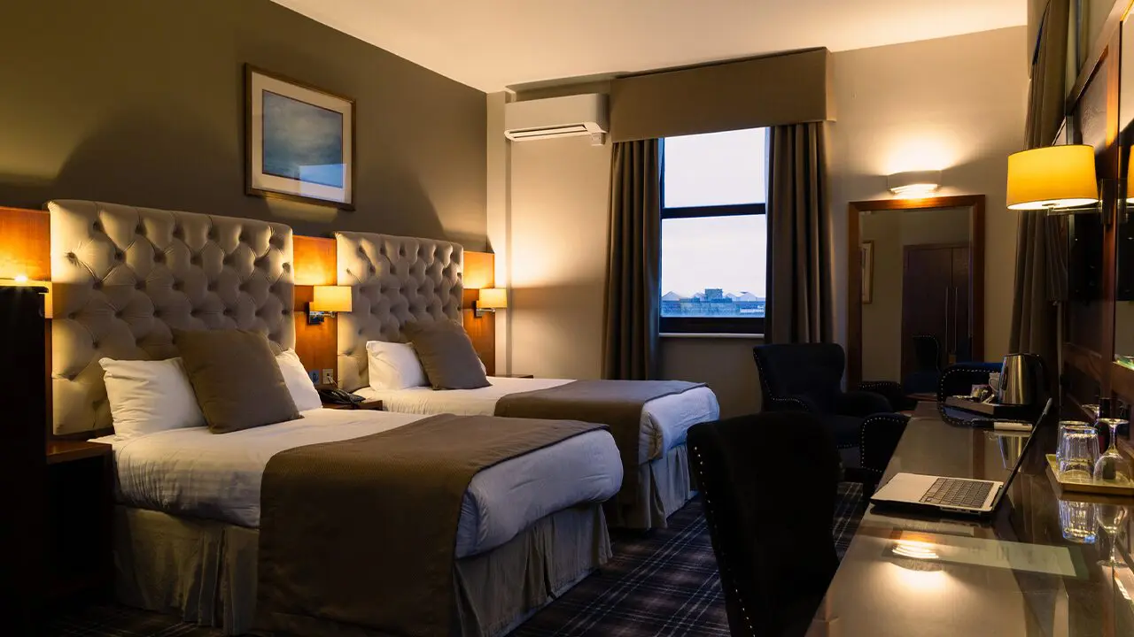 hotelRoom A hotel room with two beds and a window
